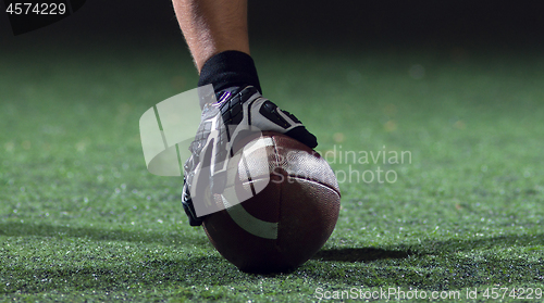 Image of American football player starting football game