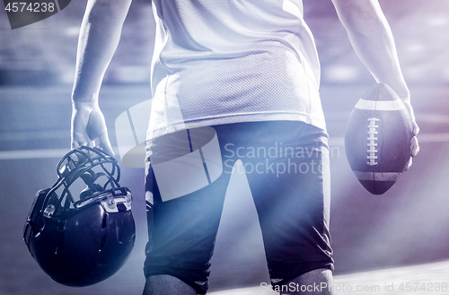 Image of rear view of young confident American football player