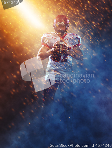 Image of portrait of confident American football player standing on the f