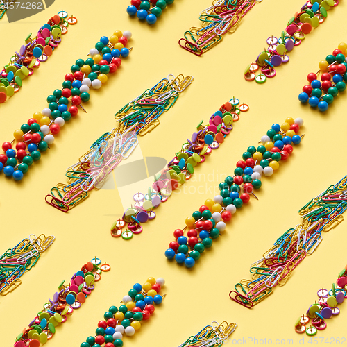 Image of Stationery colorful pins and paper clips pattern.