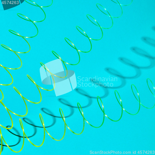 Image of Stretching plastic springs with shadows.