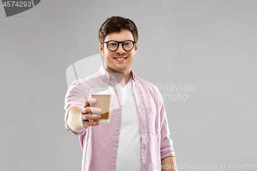 Image of young man or student in glasses drinking coffee