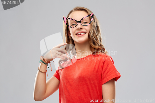 Image of smiling teenage girl with party glasses