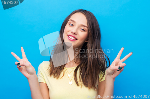 Image of young woman or teenage girl showing peace sign