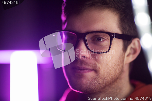 Image of portrait of man in glasses over neon lights