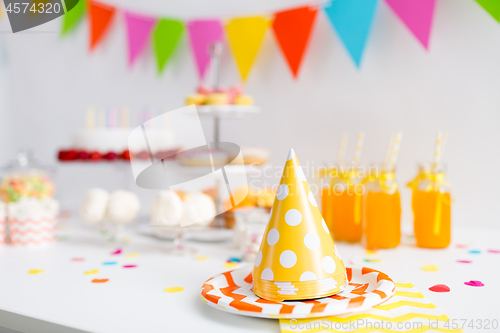 Image of party caps, food and drinks on birthday