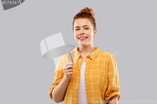 Image of happy red haired teenage girl with ice cream cone