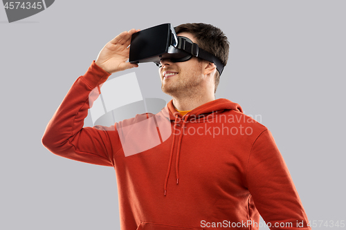 Image of happy man in virtual reality headset or vr glasses