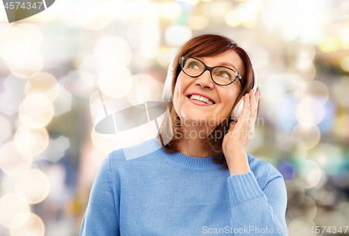 Image of senior woman in headphones listening to music