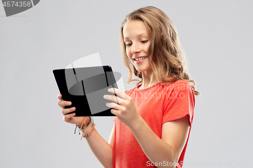 Image of smiling teenage girl with tablet computer