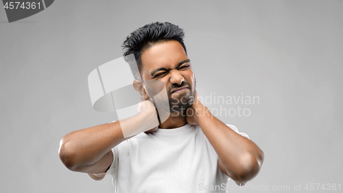 Image of tired indian man suffering from neck pain