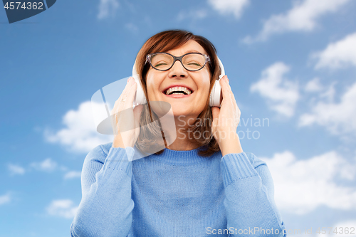 Image of senior woman in headphones listening to music