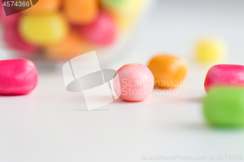 Image of close up of candy drops over white background