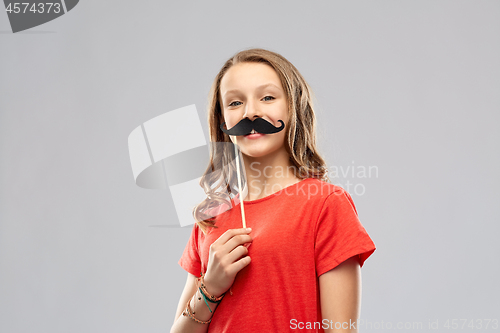 Image of smiling teenage girl with mustaches party prop