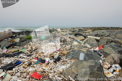 Image of Spilled garbage on the beach near the big city. Empty used dirty plastic bottles and other garbage. Environmental pollution. Ecological problem.