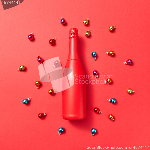 Image of Holiday composition red painted mockup bottle on a Christmac background.