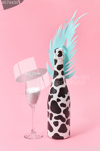 Image of Creative set of painted wine bottle and glass of white powder.