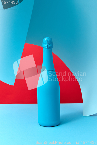 Image of Holiday wine mock-up bottle painted blue with soft shadows.
