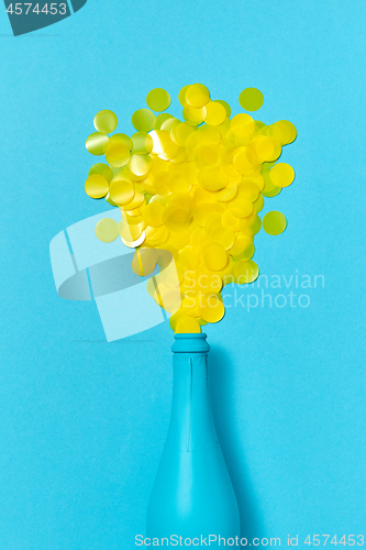 Image of Blue painted champagne bottle with yellow confetti bubbles.