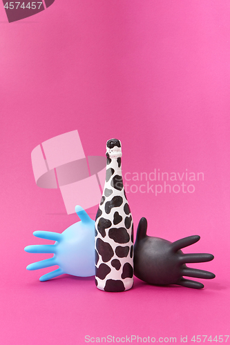 Image of Two balloon latex gloves with spotted wine bottle painted.