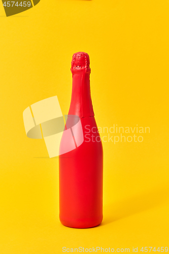 Image of Red painted spray mockup bottle on an yellow background.