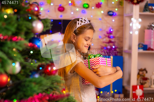 Image of Beautiful ten-year-old girl received a gift from Santa Claus