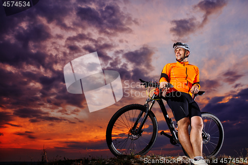 Image of Man in helmet and glasses stay on the bicycle