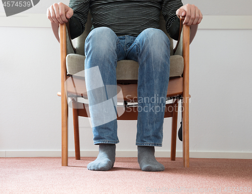 Image of Man in armchair, slightly creepy 