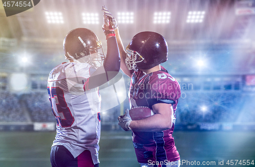 Image of american football players celebrating after scoring a touchdown