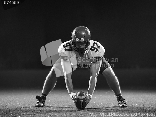 Image of American football player starting football game