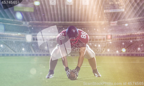 Image of American football player starting football game