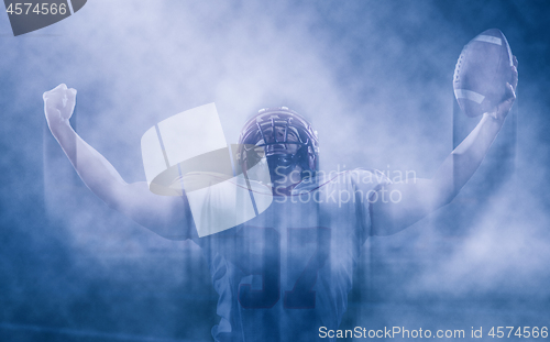 Image of american football player celebrating after scoring a touchdown