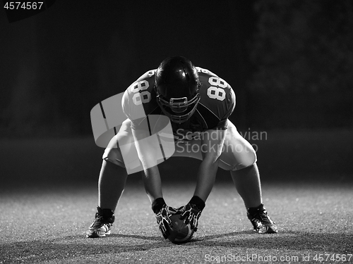 Image of American football player starting football game