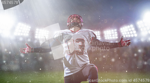 Image of american football player celebrating after scoring a touchdown