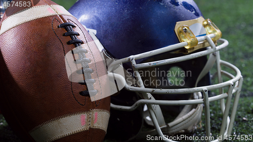 Image of closeup of american football,helmets and trophy