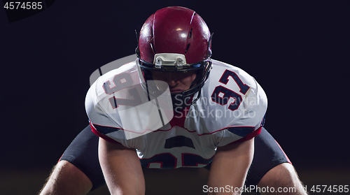 Image of American football player starting football game