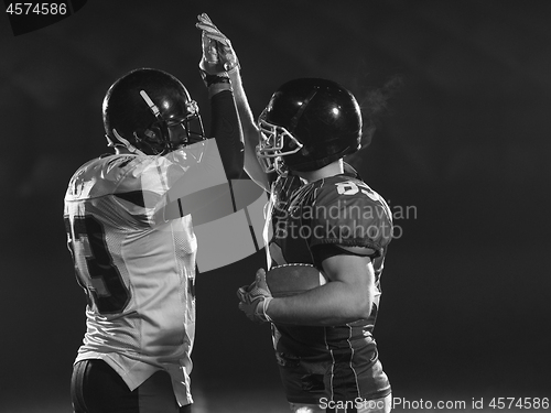 Image of american football players celebrating after scoring a touchdown