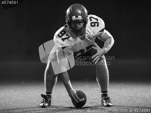 Image of American football player starting football game