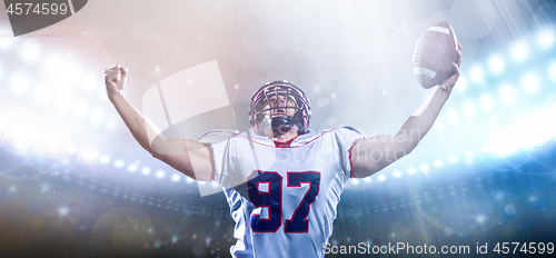 Image of american football player celebrating after scoring a touchdown