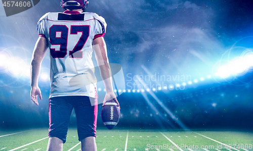 Image of rear view of young confident American football player on the fie