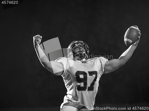 Image of american football player celebrating after scoring a touchdown