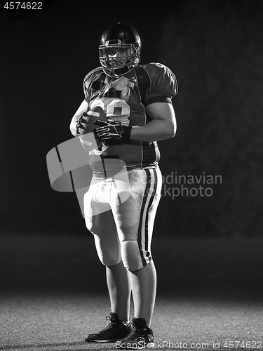 Image of portrait of confident American football player