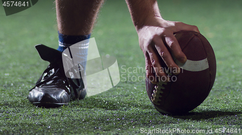 Image of American football player starting football game