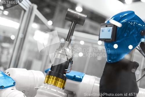 Image of Automatic robot arm working in industrial environment