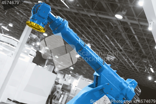 Image of Automatic robot arm working in industrial environment