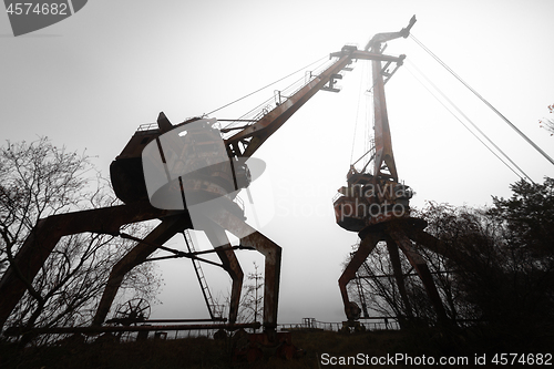 Image of Rusty old industrial dock cranes at the Dock