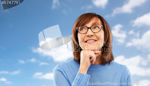 Image of portrait of senior woman in glasses dreaming