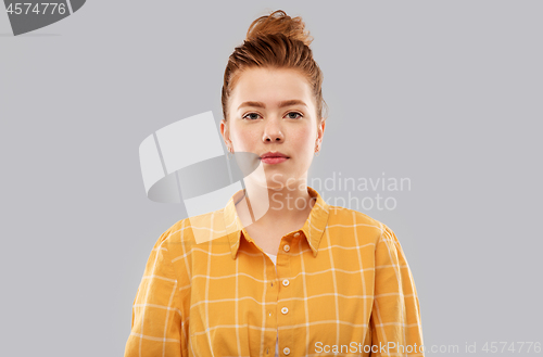 Image of red haired teenage girl in checkered shirt