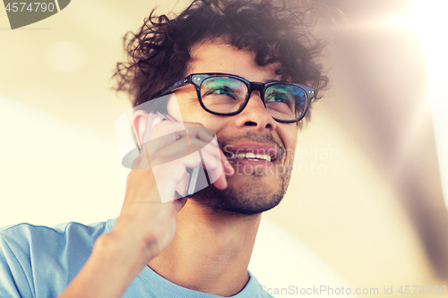 Image of man with smartphone calling on city street