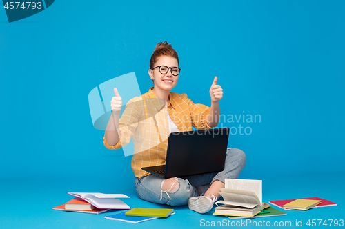 Image of teenage student girl with laptop showing thumbs up